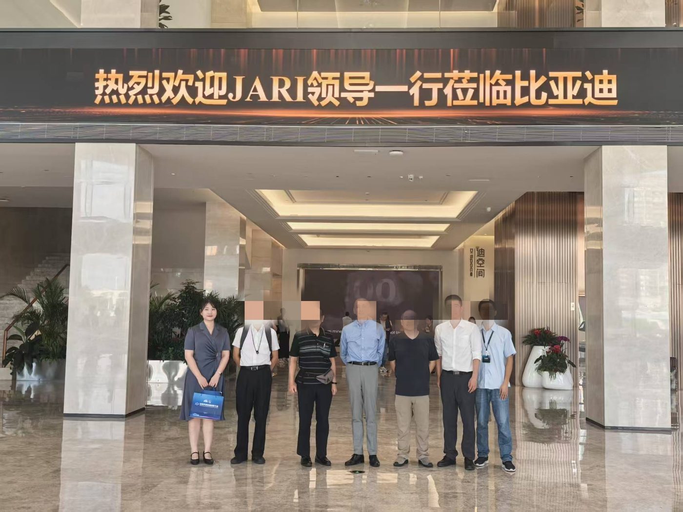 Interpreter with a client during a BYD factory tour in Shenzhen